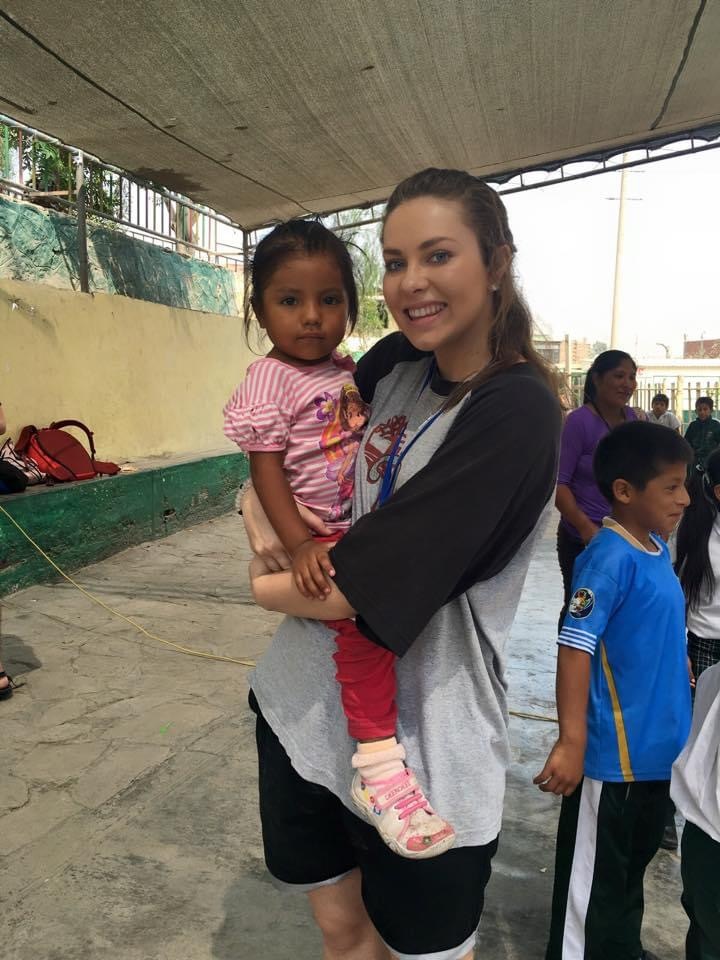 Jordan carrying a child on her hip