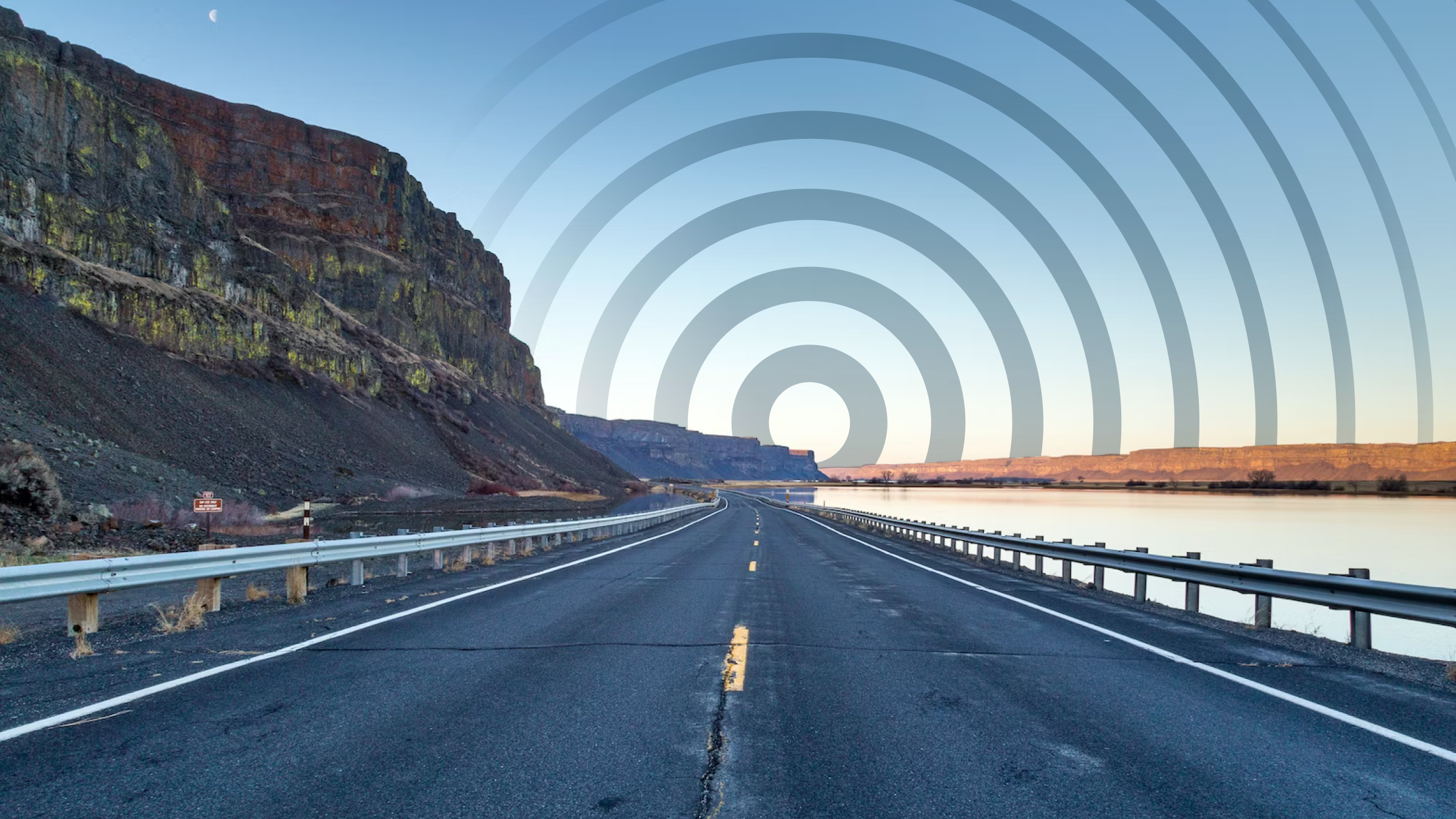 A road on the side of a river with a swirl graphic in the sky