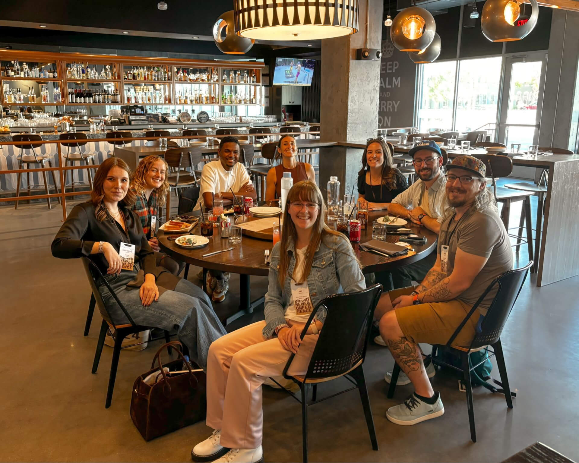 A group of designers from the 2024 Brand New Conference sitting around a lunch table.