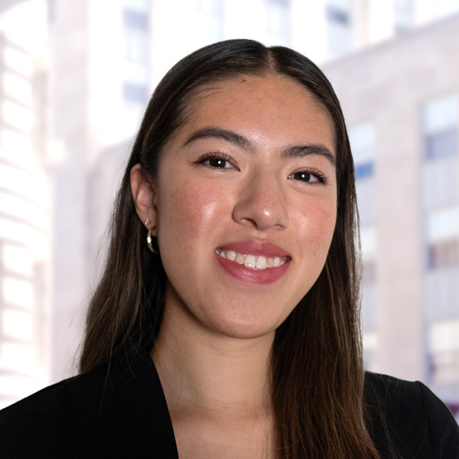 shannon's headshot smiling with the city background