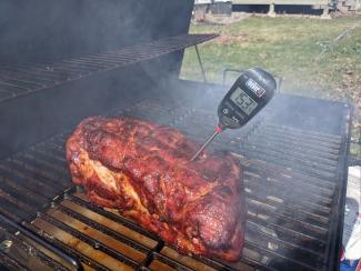 pork shoulder being barbecued