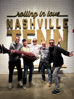The team in front of a Nashville sign