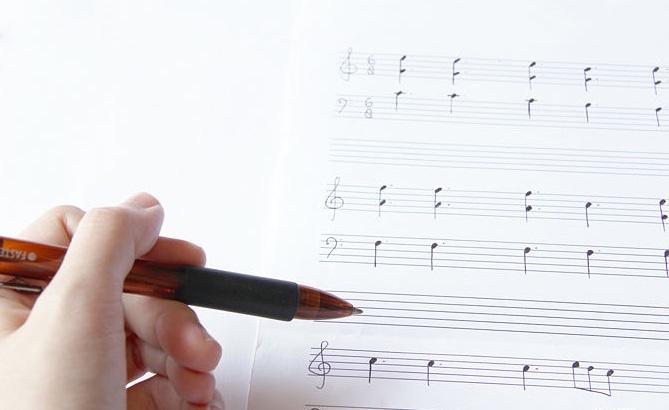 Person writing sheet music